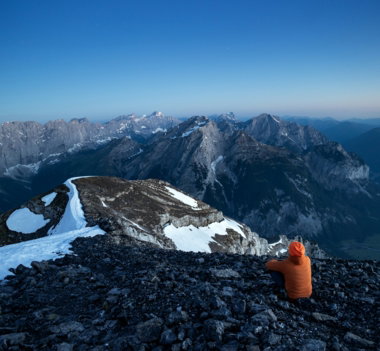 person-on-rocky-peak-overlooks-vast-mountain-range-at-dawn-.jpg Person on rocky peak overlooks vast mountain range at dawn.